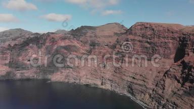 空中射击。 巨大的<strong>黑</strong>红色火山岩是海洋蓝色水域中的一座山。 对着蓝天。 加那利
